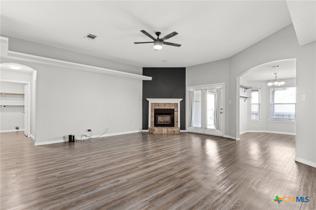4305 Maggie Drive Killeen, TX 76549 - Photo 3 of 14 a view of an empty room with wooden floor and a fireplace