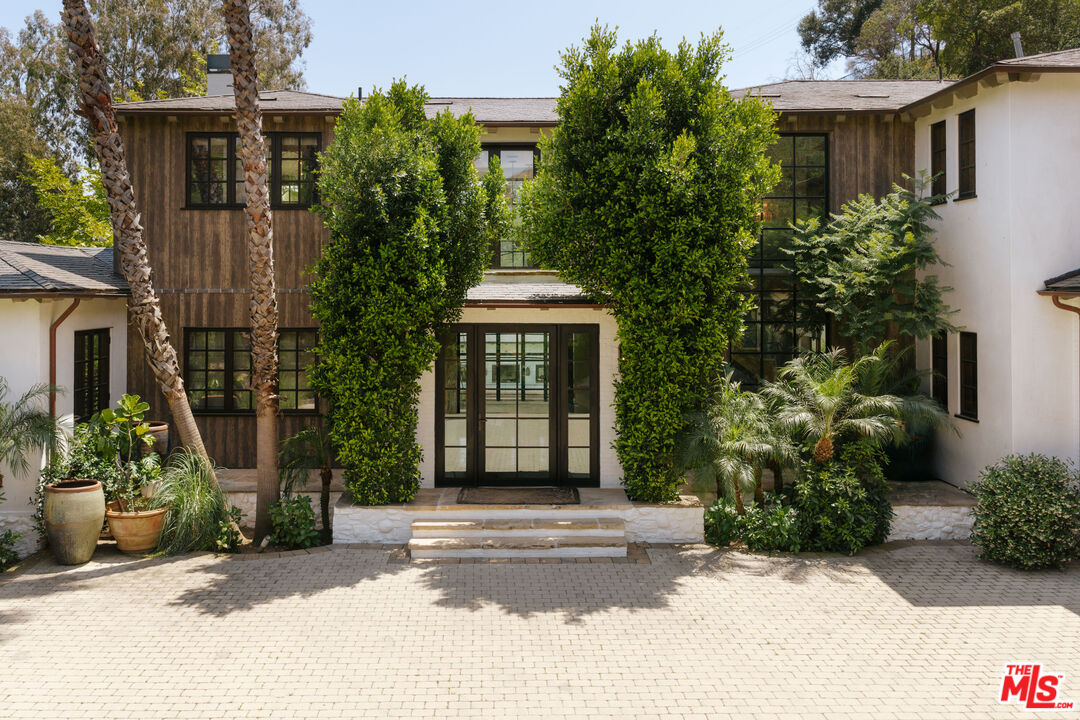 1105 Rivas Canyon Road Pacific Palisades, CA 90272 - Photo 4 of 49 a front view of a house with garden