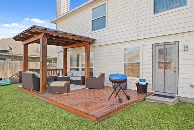 a view of a house with backyard and sitting area