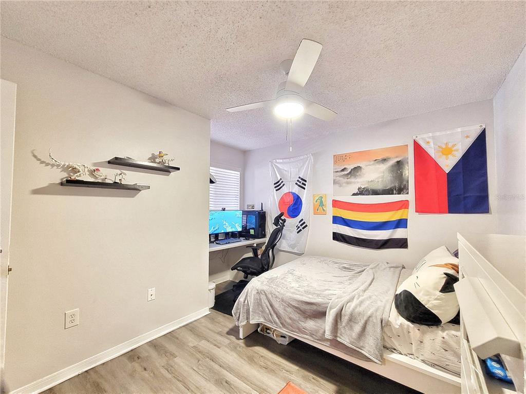 2601 Southwest Archer Road, Unit H330 Gainesville, FL 32608 - Photo 13 of 28 a bedroom with a bed and a chandelier