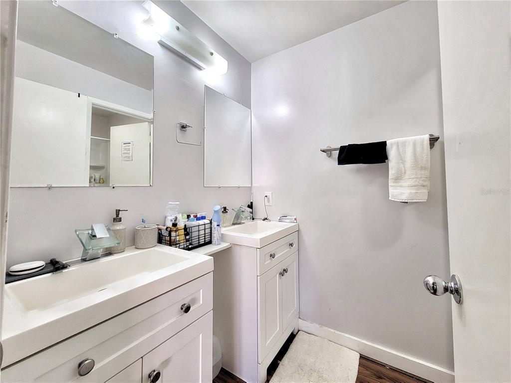 2601 Southwest Archer Road, Unit H330 Gainesville, FL 32608 - Photo 14 of 28 a bathroom with a sink vanity and mirror
