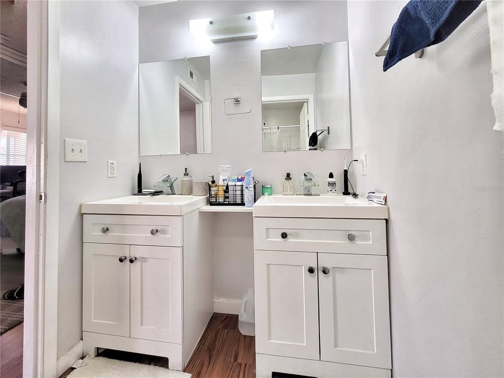 2601 Southwest Archer Road, Unit H330 Gainesville, FL 32608 - Photo 15 of 28 a bathroom with a sink vanity and a mirror