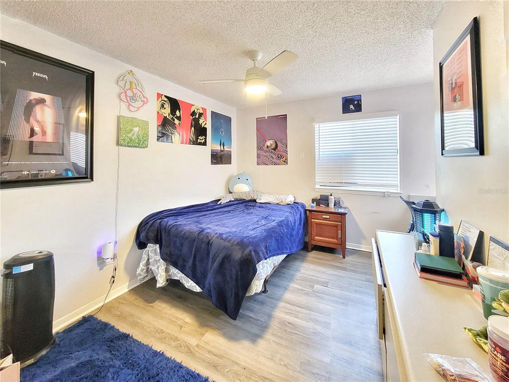 2601 Southwest Archer Road, Unit H330 Gainesville, FL 32608 - Photo 17 of 28 a spacious bedroom with a bed and wooden floor