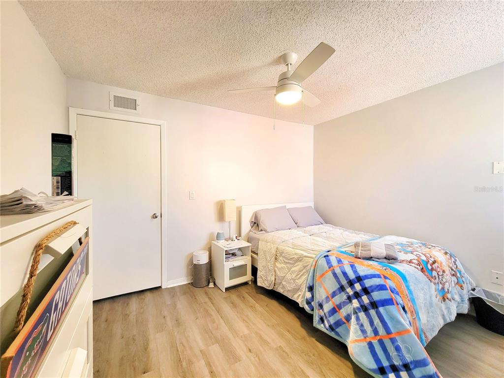 2601 Southwest Archer Road, Unit H330 Gainesville, FL 32608 - Photo 21 of 28 a bedroom with a bed and a chandelier