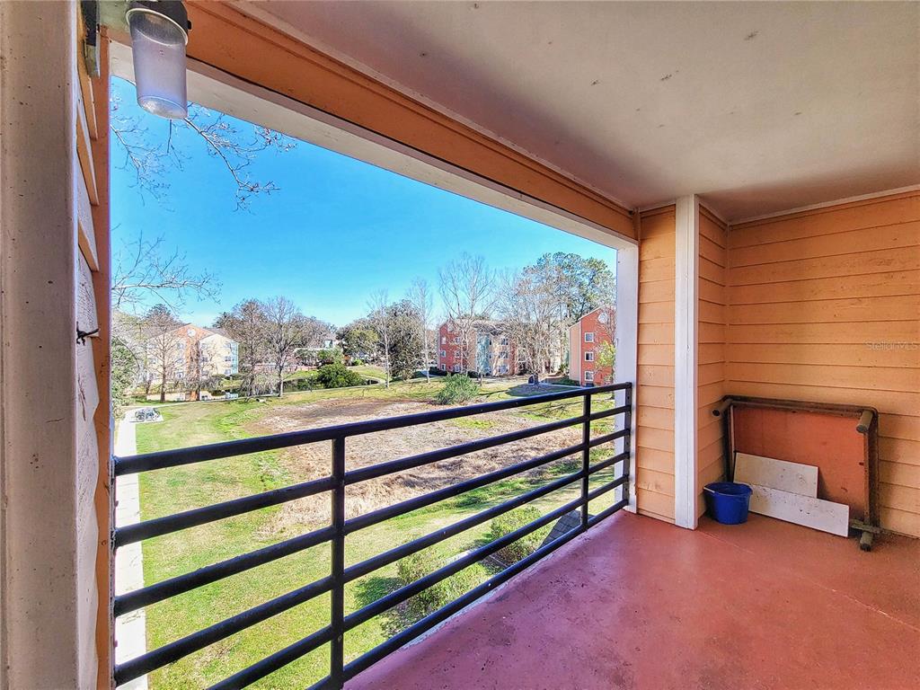 2601 Southwest Archer Road, Unit H330 Gainesville, FL 32608 - Photo 24 of 28 a view of a porch with furniture and a yard