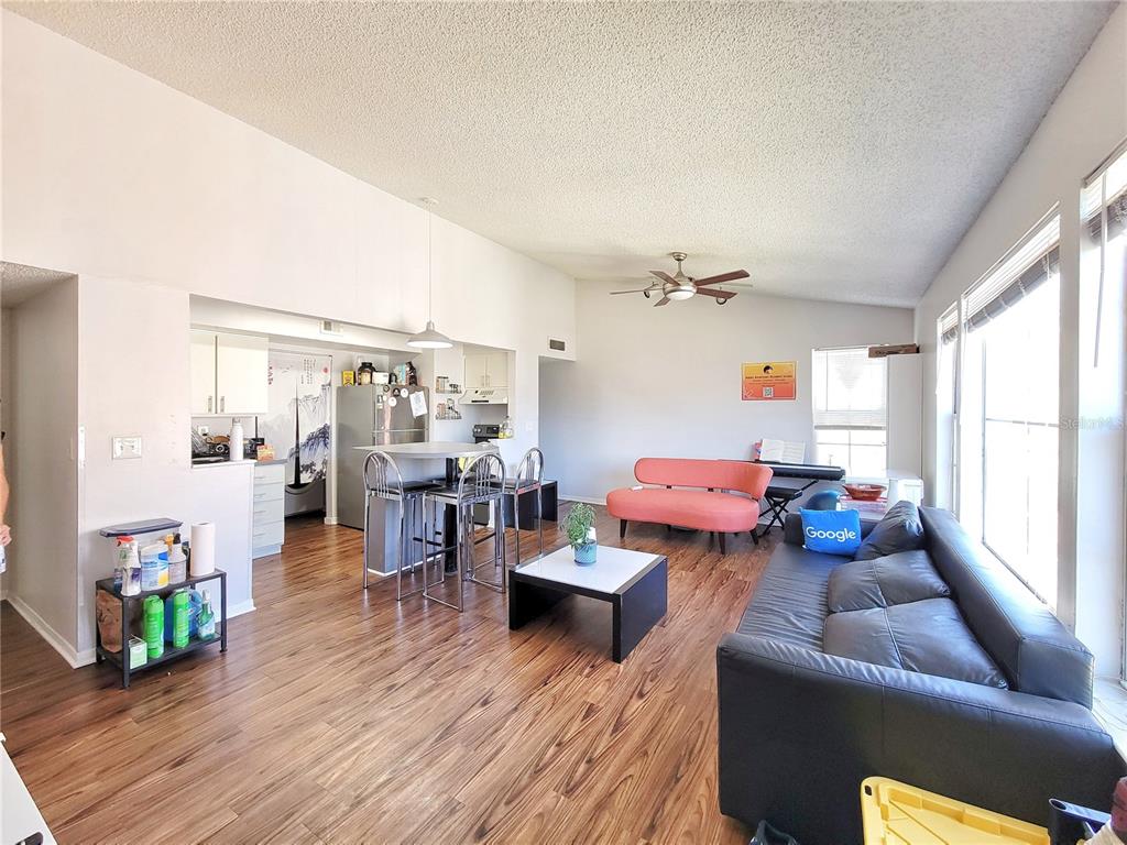 2601 Southwest Archer Road, Unit H330 Gainesville, FL 32608 - Photo 3 of 28 a living room with furniture and wooden floor