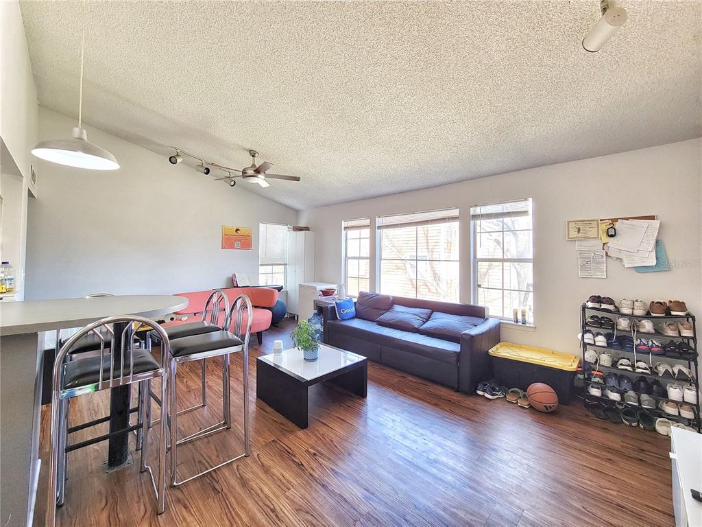 2601 Southwest Archer Road, Unit H330 Gainesville, FL 32608 - Photo 5 of 28 a living room with furniture and wooden floor