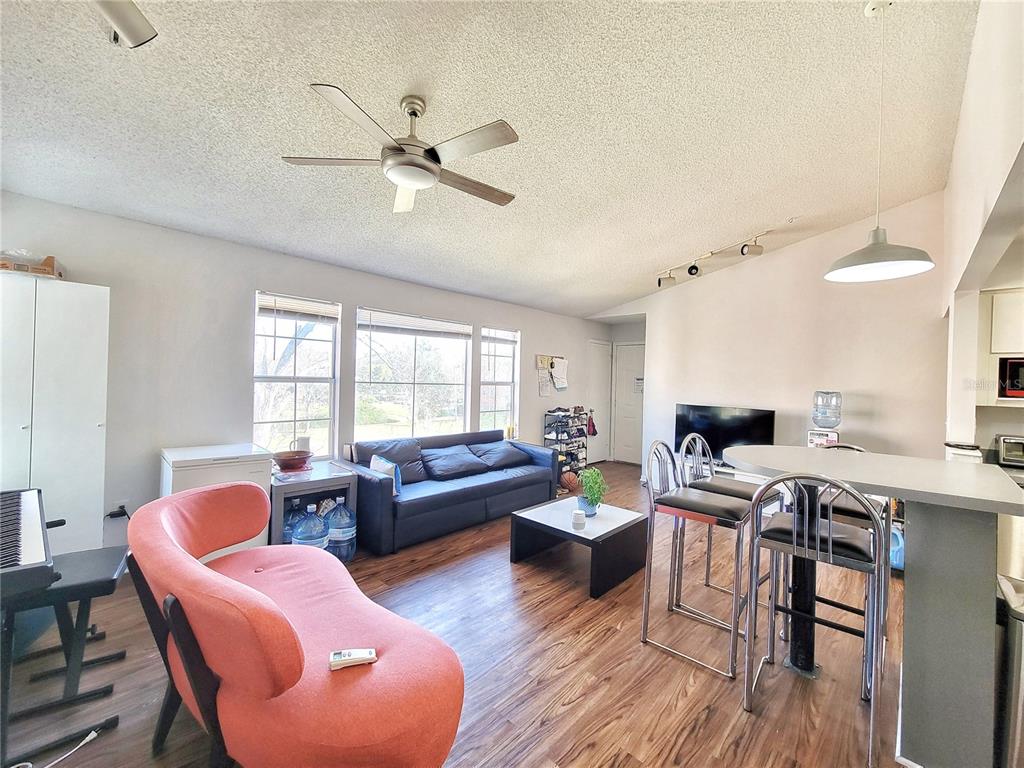 2601 Southwest Archer Road, Unit H330 Gainesville, FL 32608 - Photo 6 of 28 a living room with furniture a wooden floor and a window