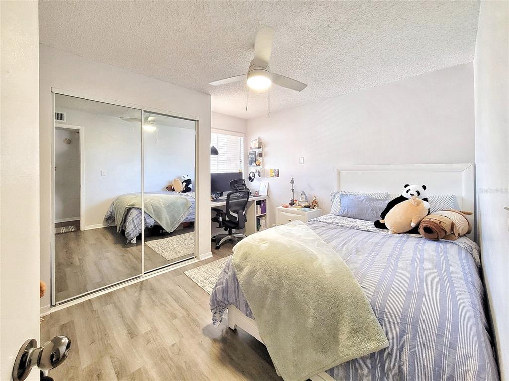 2601 Southwest Archer Road, Unit H330 Gainesville, FL 32608 - Photo 10 of 28 a bedroom with a bed and view of living room