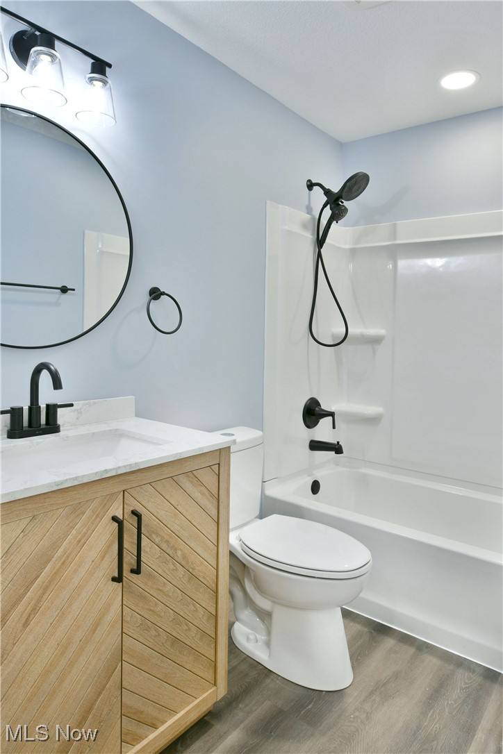 2096 Stillwagon Road Southeast Warren, OH 44484 - Photo 26 of 50 Full bathroom with toilet, shower / washtub combination, wood finished floors, and vanity
