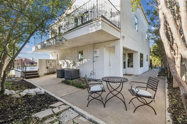 an aerial view of residential houses with outdoor space and trees