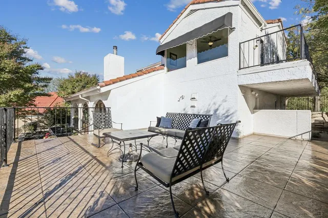 a front view of a house with garden and patio