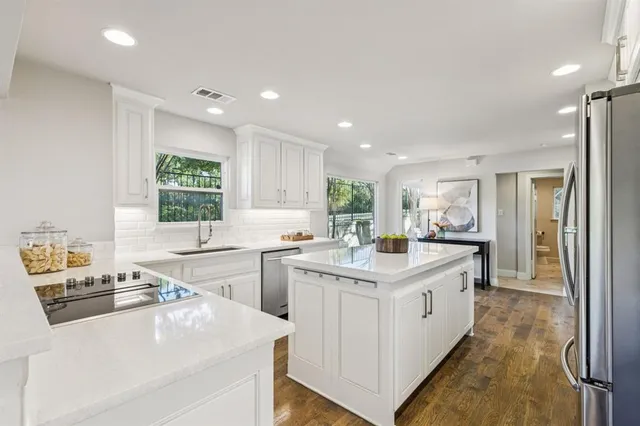 a spacious bathroom with a bathtub and potted plant