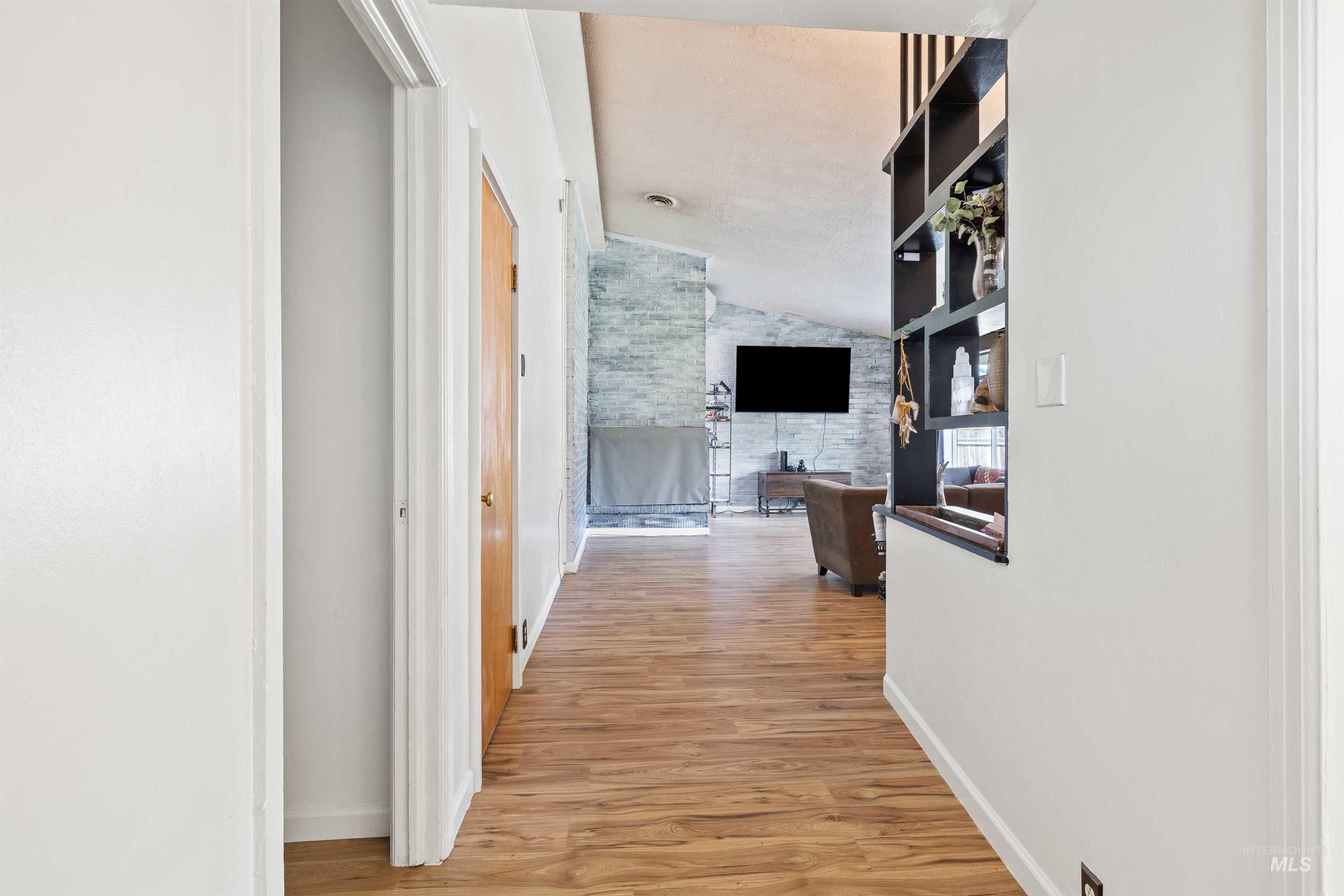 817 Union Avenue Filer, ID 83328 - Photo 3 of 37 Hallway with light wood-style flooring and vaulted ceiling