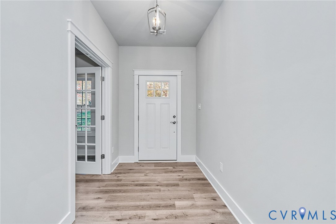 14270 Tower Road Beaverdam, VA 23015 - Photo 5 of 9 an empty room with wooden floor cabinet and windows