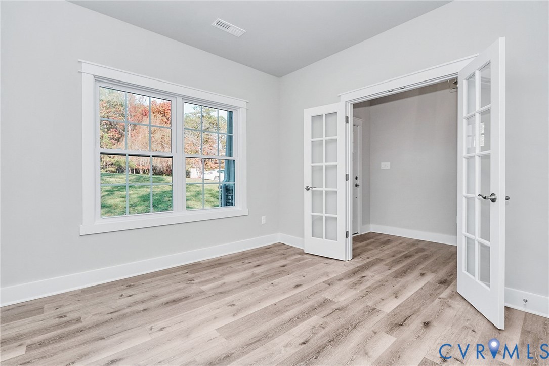 14270 Tower Road Beaverdam, VA 23015 - Photo 6 of 9 an empty room with wooden floor and windows