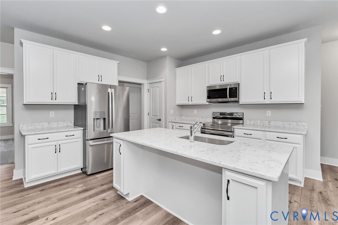 14270 Tower Road Beaverdam, VA 23015 - Photo 7 of 9 a kitchen with stainless steel appliances granite countertop a refrigerator stove microwave and sink
