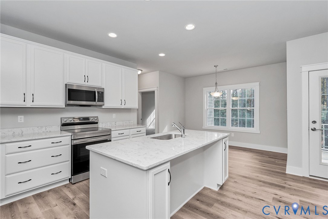 14270 Tower Road Beaverdam, VA 23015 - Photo 8 of 9 a kitchen with a stove a sink and a microwave