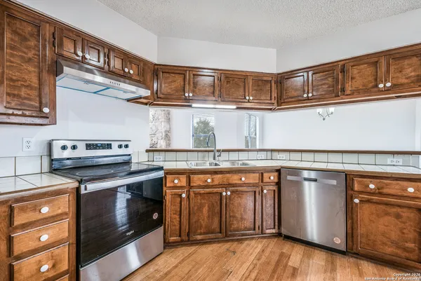 a kitchen with stainless steel appliances granite countertop a stove and a cabinets