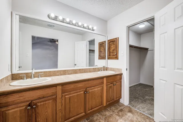 a bathroom with a sink double vanity and a mirror
