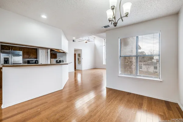 a view of a kitchen with a dishwasher cabinets and wooden floor