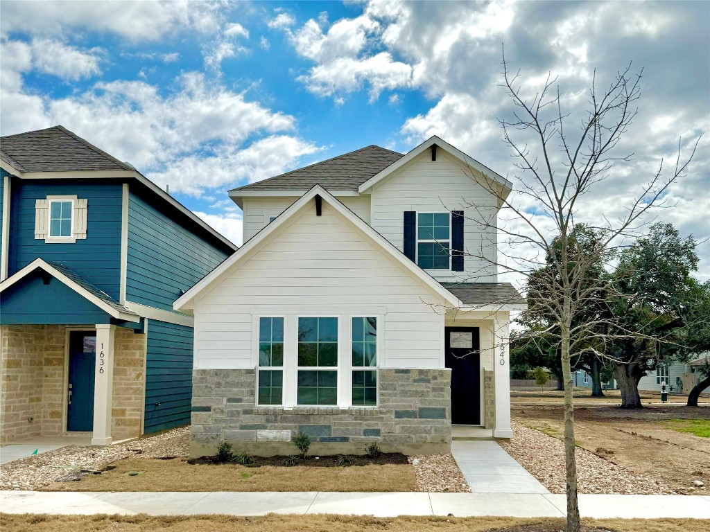 a front view of a house with a garden