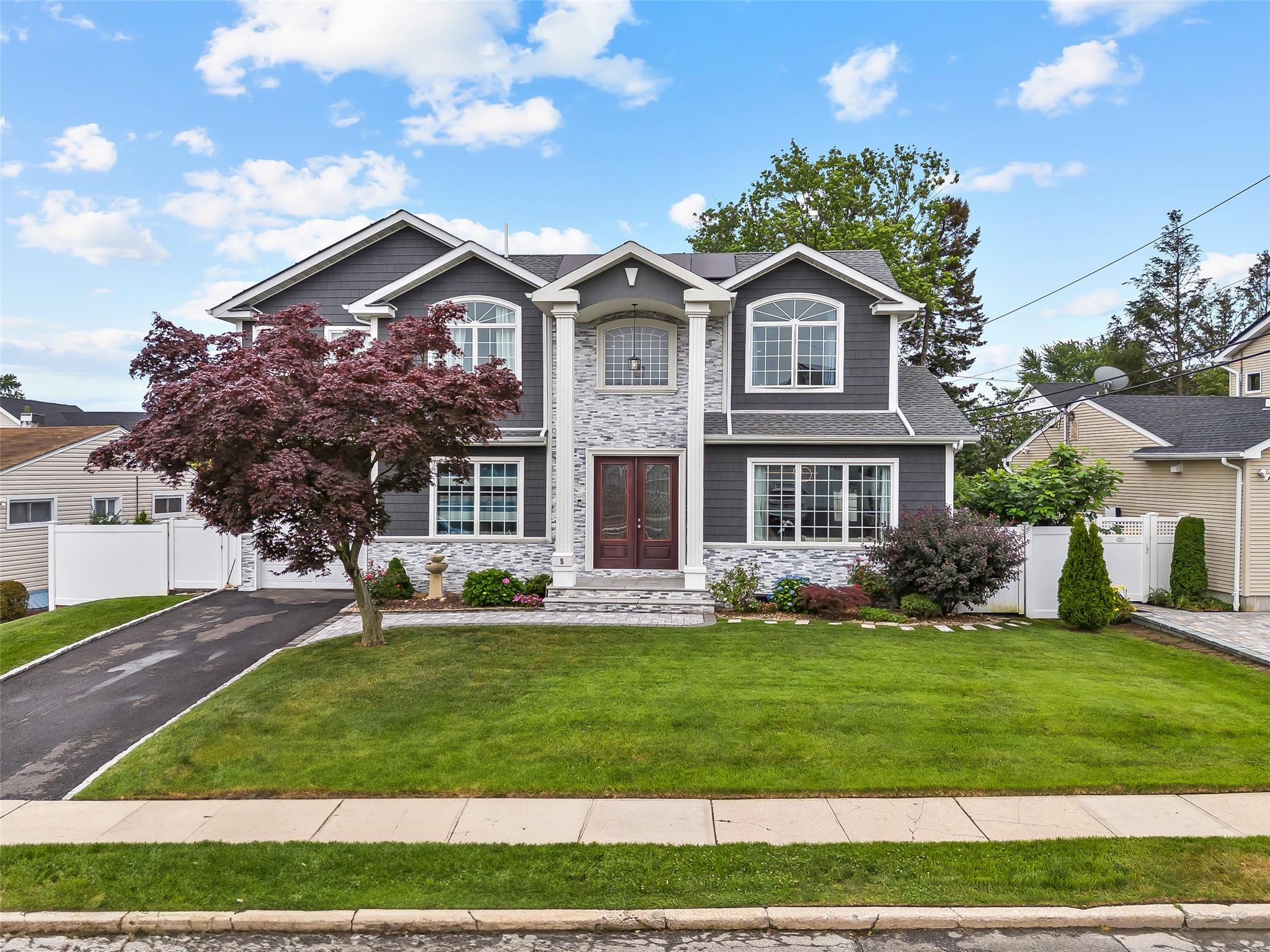 5 Vera Avenue Plainview, NY 11803 - Photo 1 of 1 Traditional-style house featuring french doors, stone siding, driveway, and a garage