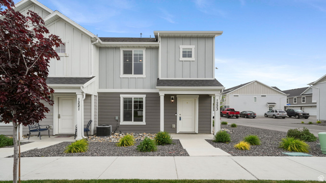 1223 East 1775 North Payson, UT 84651 - Photo 41 of 45 Modern townhome exterior featuring multi-toned siding, white trim, a covered entry, and a paved walkway