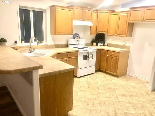 a kitchen with a sink stove and cabinets