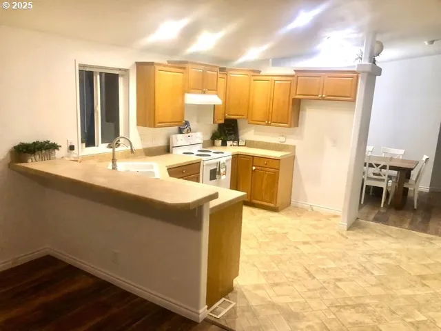 a kitchen with a sink stove and cabinets