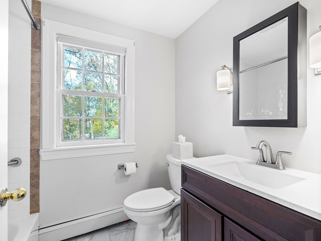 31 Bay State Road Wellesley, MA 02481 - Photo 18 of 24 a bathroom with a sink vanity mirror and toilet