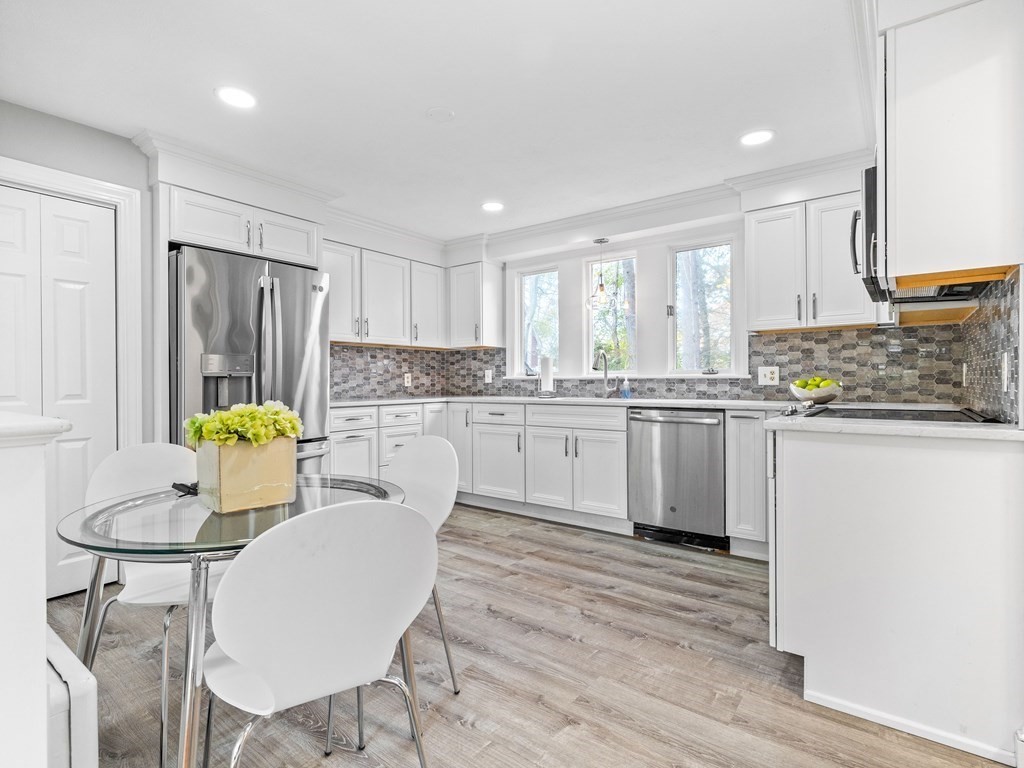 31 Bay State Road Wellesley, MA 02481 - Photo 7 of 24 a kitchen with stainless steel appliances granite countertop a white cabinets and wooden floor