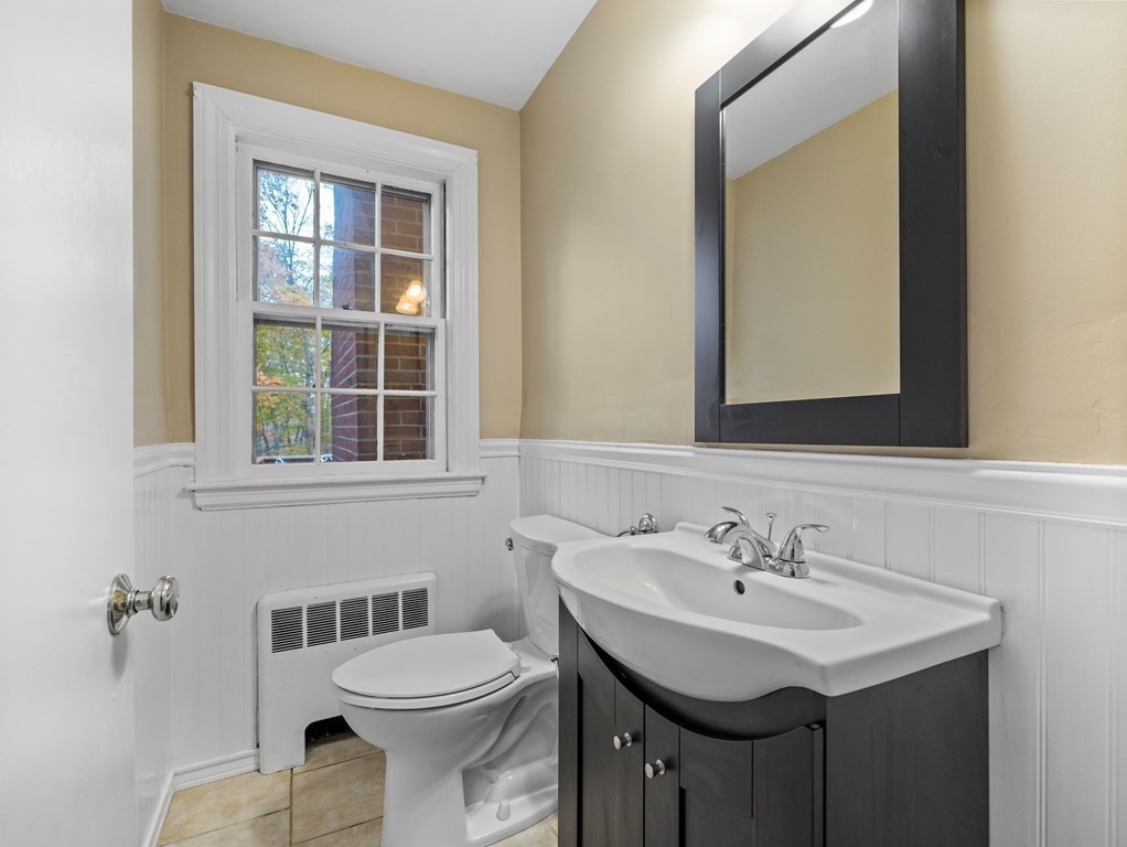 31 Bay State Road Wellesley, MA 02481 - Photo 8 of 24 a bathroom with a sink a toilet and mirror