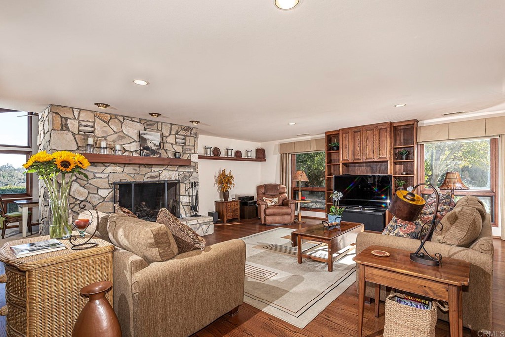16854 Los Morros Rancho Santa Fe, CA 92067 - Photo 13 of 40 a living room with furniture a fireplace and a flat screen tv