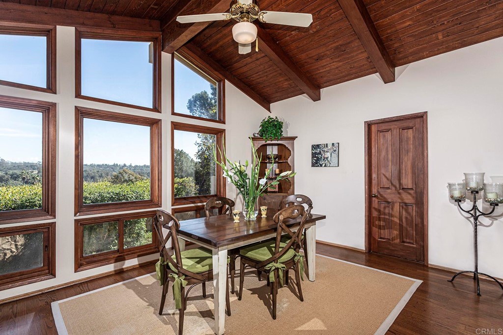 16854 Los Morros Rancho Santa Fe, CA 92067 - Photo 14 of 40 a dining room with furniture a rug and a large window