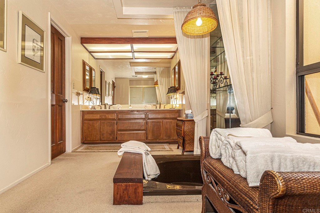 16854 Los Morros Rancho Santa Fe, CA 92067 - Photo 17 of 40 a bedroom with a bed and a chandelier