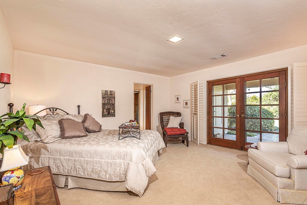 16854 Los Morros Rancho Santa Fe, CA 92067 - Photo 19 of 40 a bedroom with bed and a large window