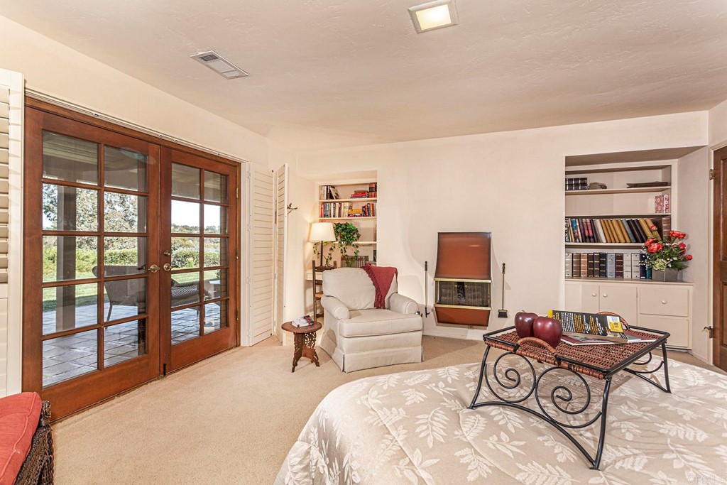 16854 Los Morros Rancho Santa Fe, CA 92067 - Photo 20 of 40 a bedroom with furniture and a floor to ceiling window