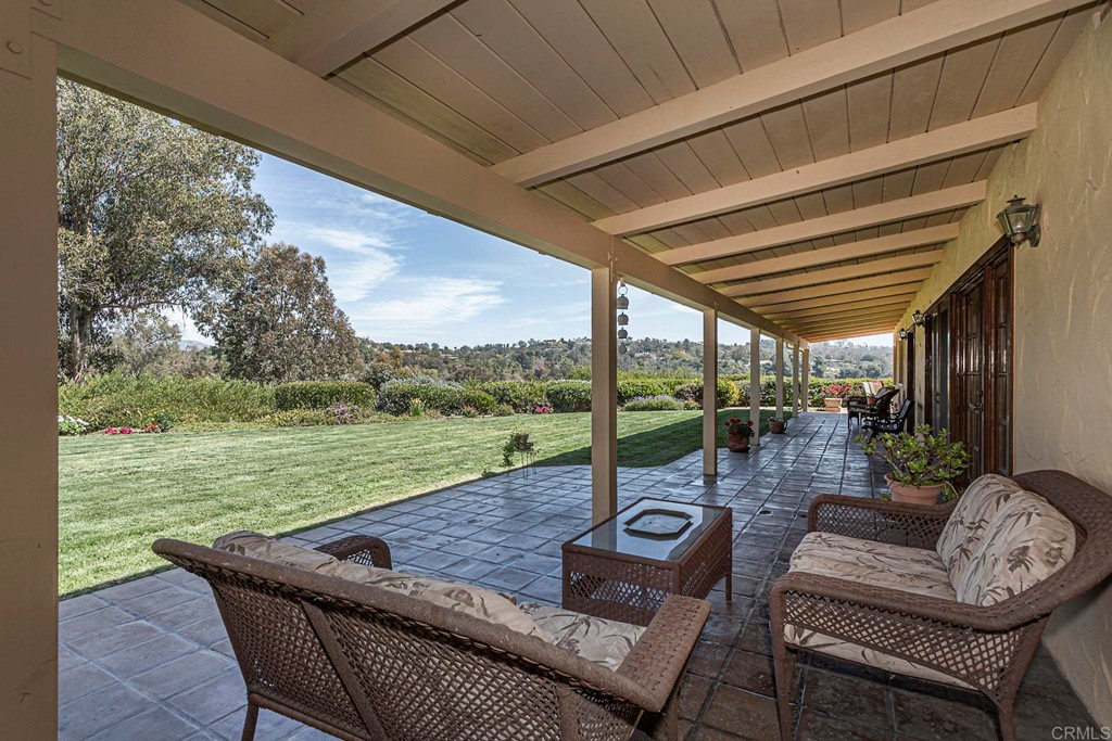 16854 Los Morros Rancho Santa Fe, CA 92067 - Photo 31 of 40 a view of a patio with couches chairs and a table