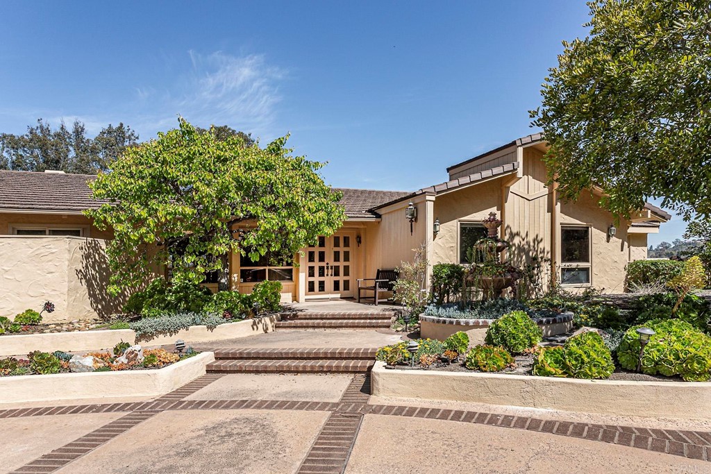16854 Los Morros Rancho Santa Fe, CA 92067 - Photo 4 of 40 a front view of a house with garden