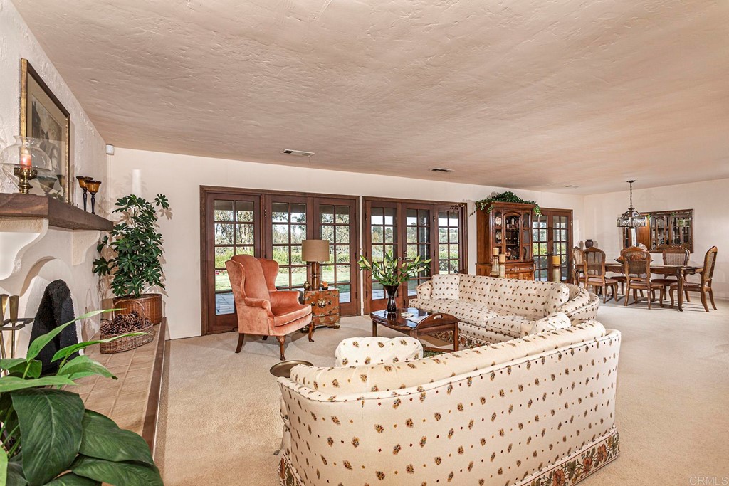 16854 Los Morros Rancho Santa Fe, CA 92067 - Photo 8 of 40 a living room with furniture fireplace and a large window