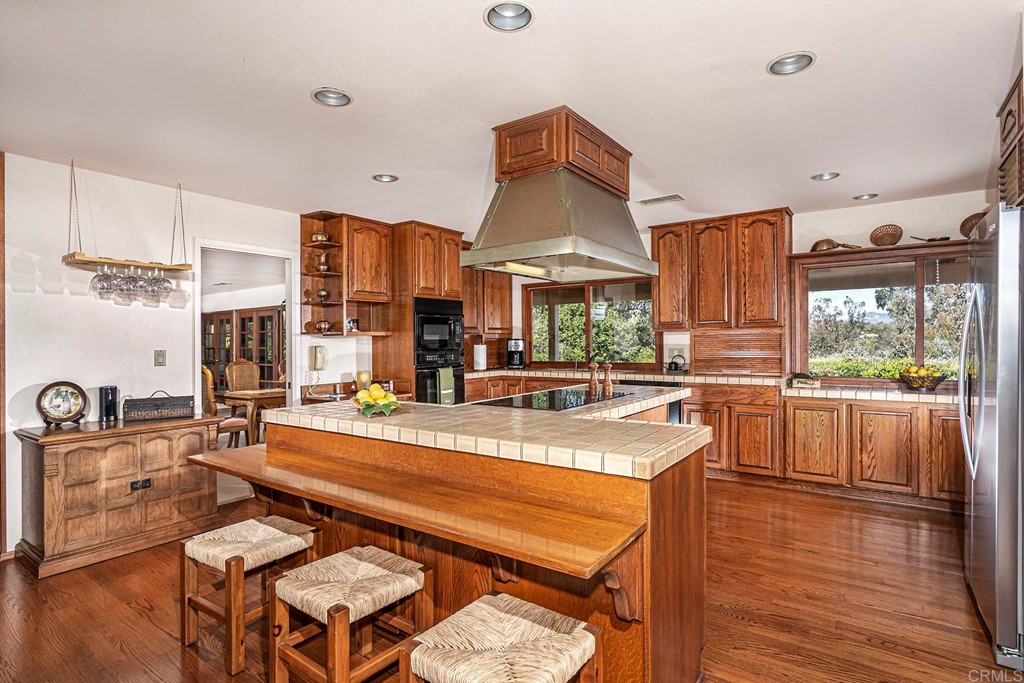 16854 Los Morros Rancho Santa Fe, CA 92067 - Photo 10 of 40 a living room with stainless steel appliances furniture a kitchen view and a large window