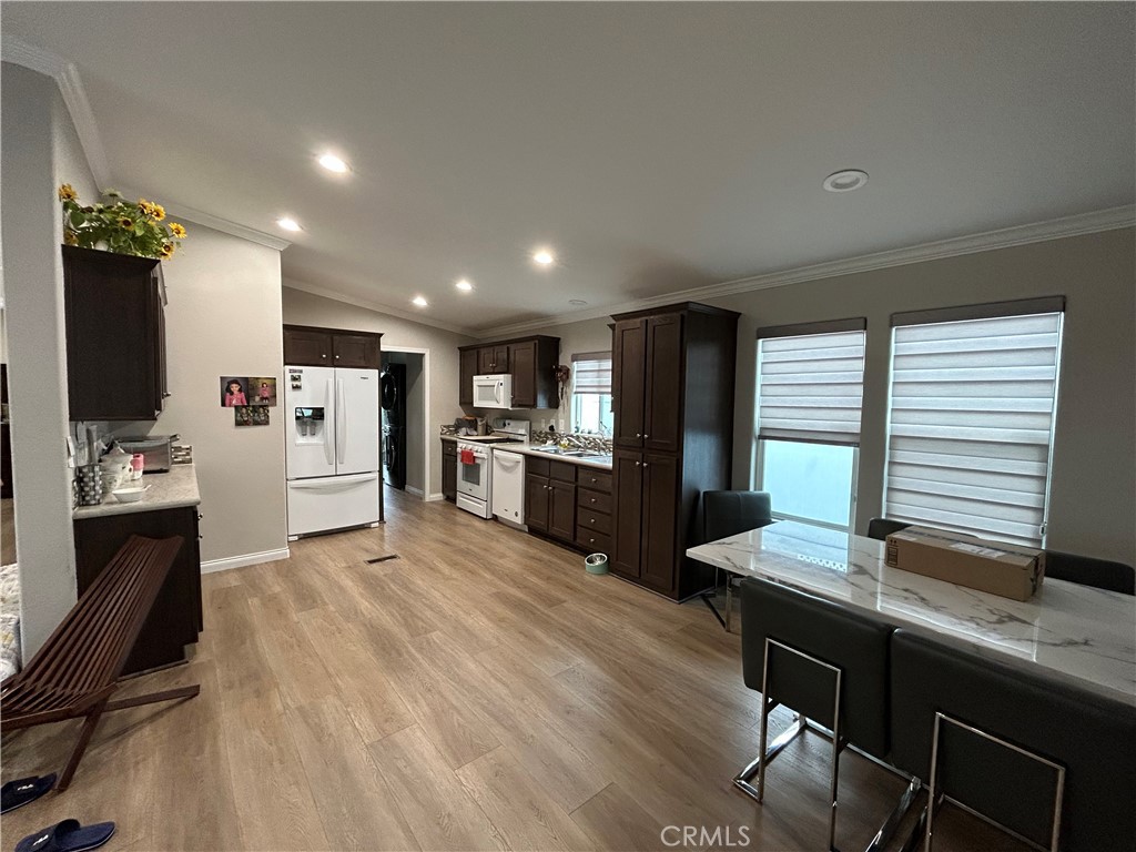 17 Gomes Way Brea, CA 92821 - Photo 10 of 47 a kitchen with stainless steel appliances kitchen island granite countertop a refrigerator oven a sink dishwasher and white cabinets with wooden floor