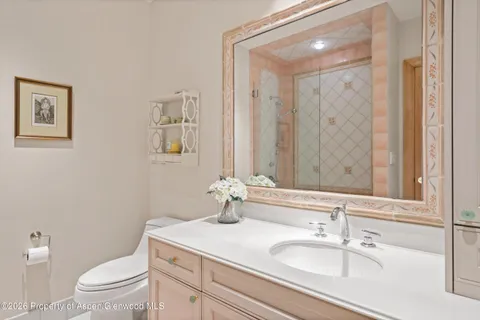 a bedroom with a bed table and window