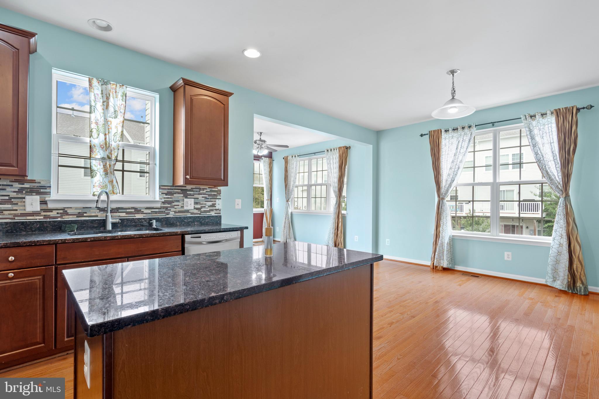 22667 Flowing Spring Square Brambleton, VA 20148 - Photo 14 of 39 a large kitchen with granite countertop a large window