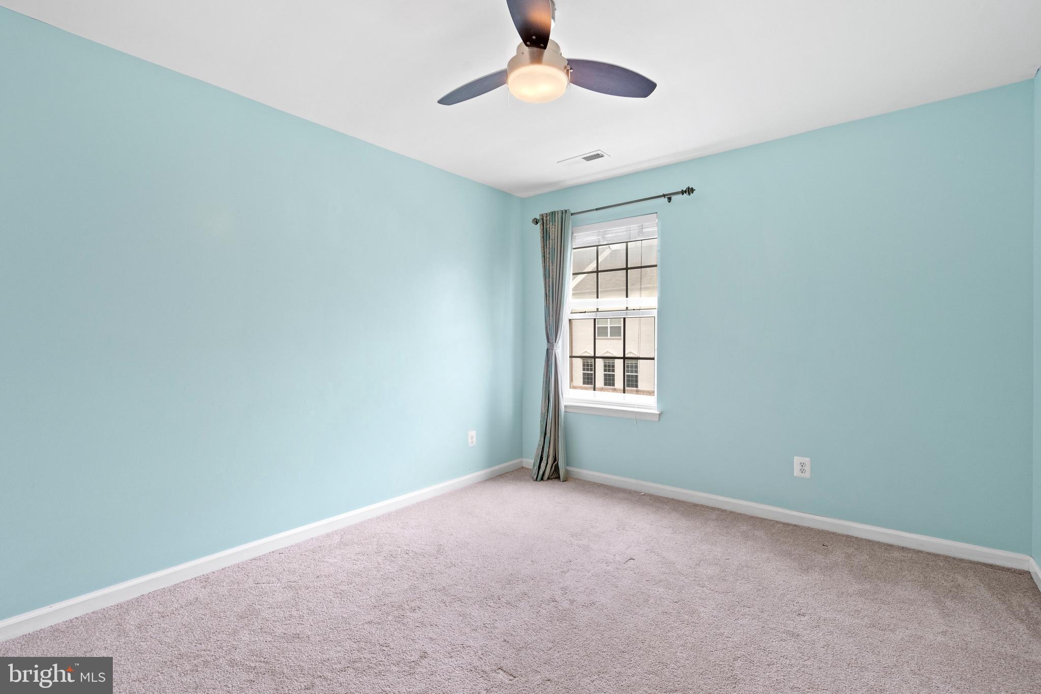 22667 Flowing Spring Square Brambleton, VA 20148 - Photo 16 of 39 an empty room with a window and a fan