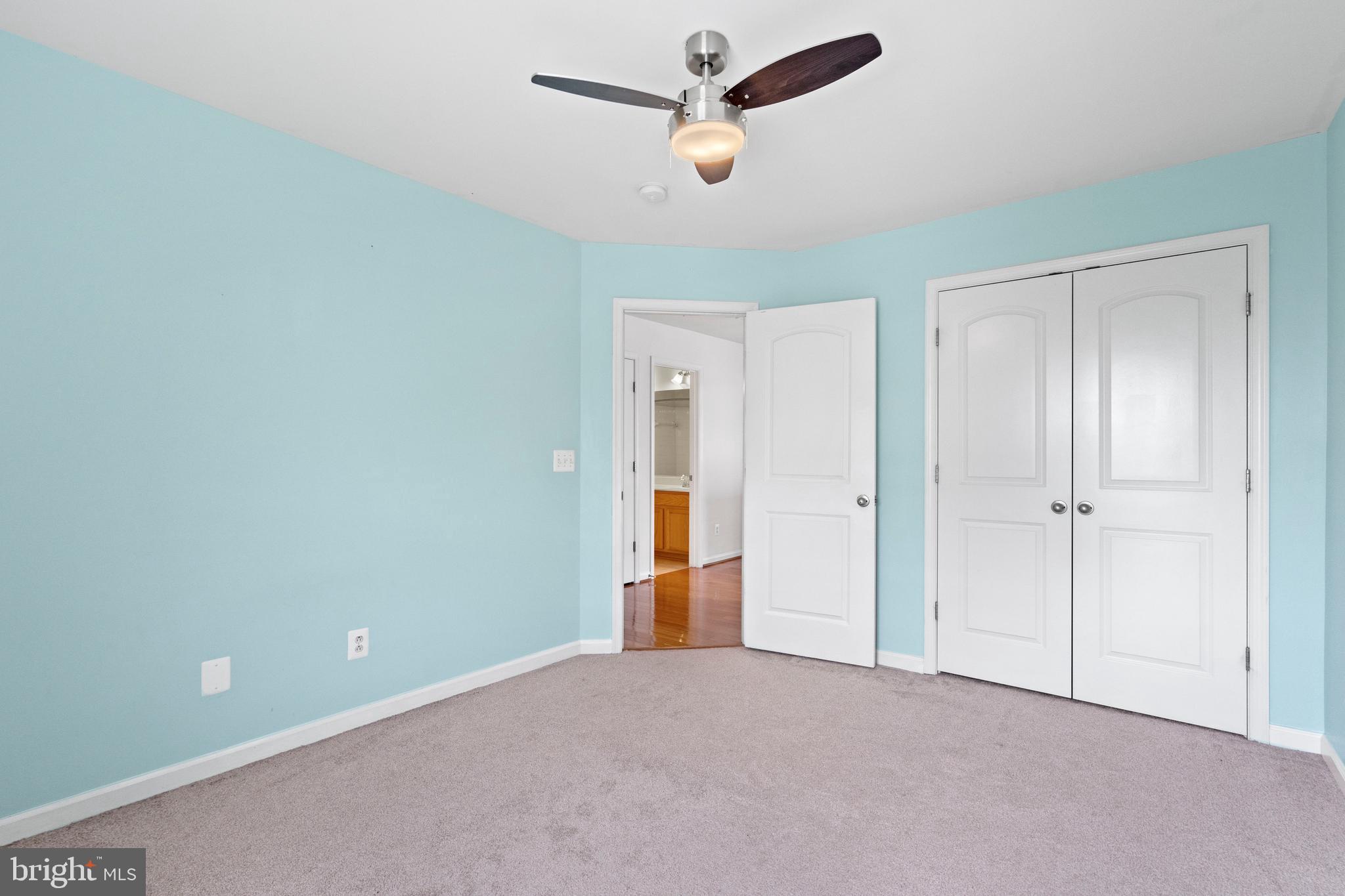 22667 Flowing Spring Square Brambleton, VA 20148 - Photo 17 of 39 a view of an empty room and a ceiling fan