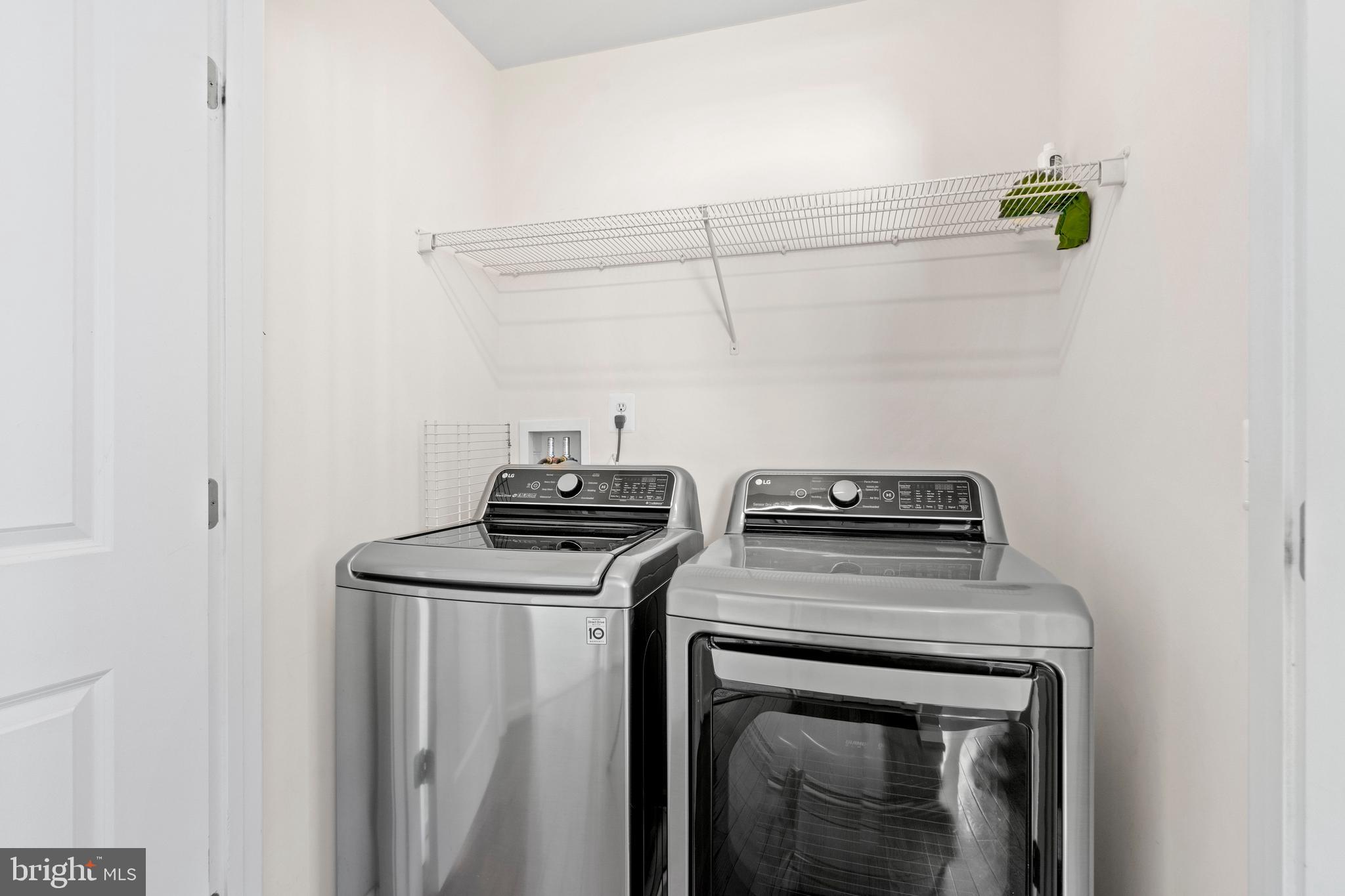 22667 Flowing Spring Square Brambleton, VA 20148 - Photo 20 of 39 a view of a storage and utility room with washer and dryer