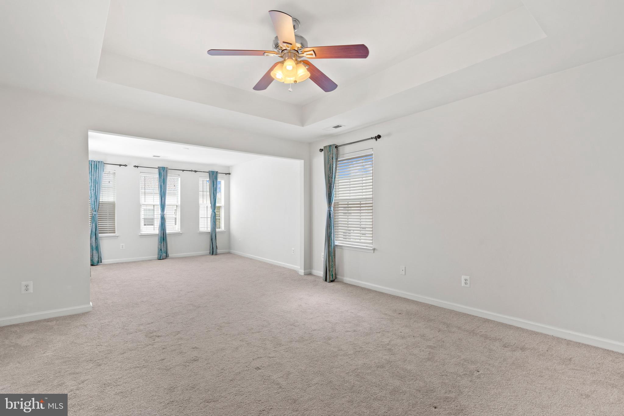 22667 Flowing Spring Square Brambleton, VA 20148 - Photo 23 of 39 an empty room with chandelier fan and window