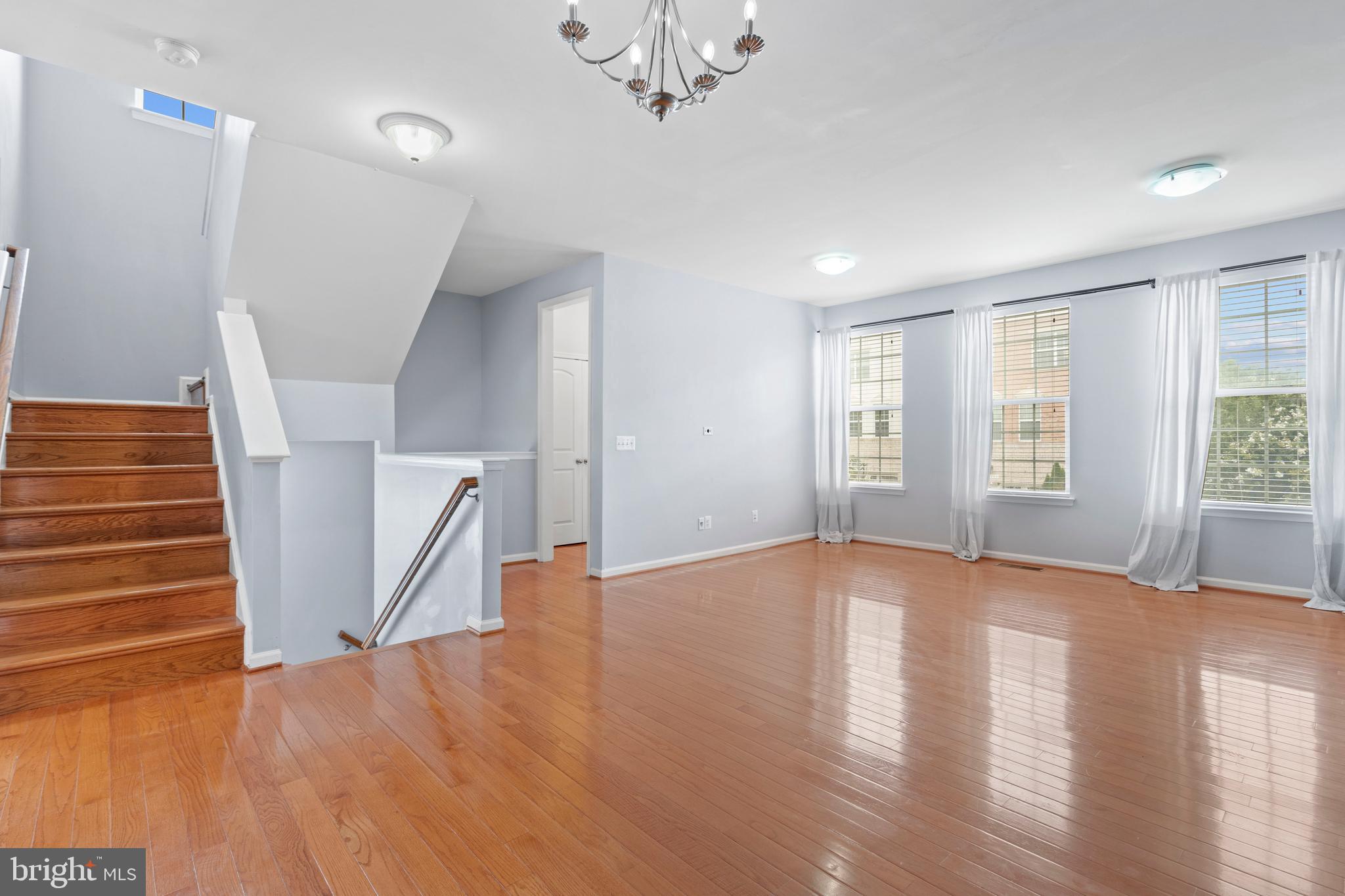 22667 Flowing Spring Square Brambleton, VA 20148 - Photo 3 of 39 a view of an empty room with wooden floor and fan
